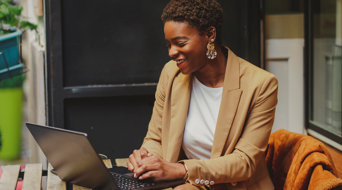 Makhongele Projects Lady sitting by laptop smilling